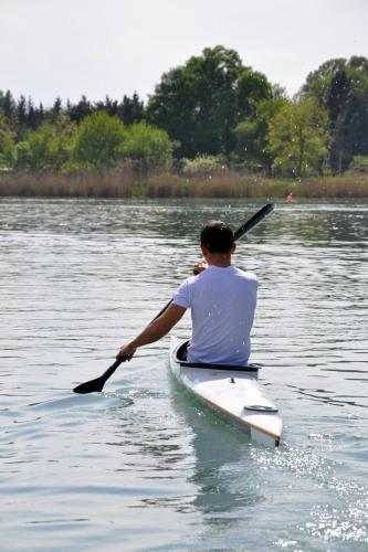 a man in a kayak on a body of water at Arena Hotel Kur in Mingachevir