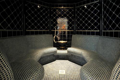 two chairs in a room with a toilet in it at Grupotel Los Príncipes & Spa in Playa de Muro