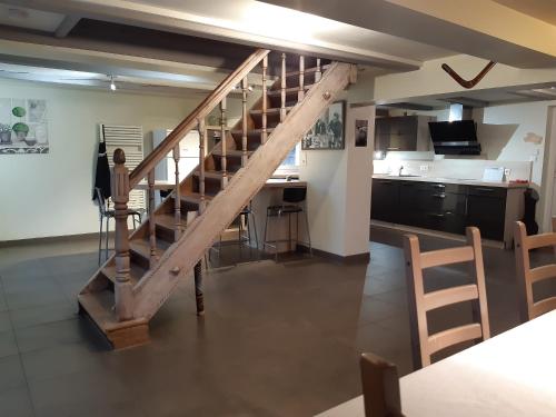 a kitchen with a wooden staircase in a room at Gîte de la Grande Rainette in Grosne