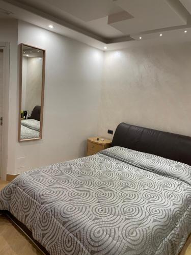 a bedroom with a bed and a mirror on the wall at B&B Rossini Luxury 2 in Cosenza