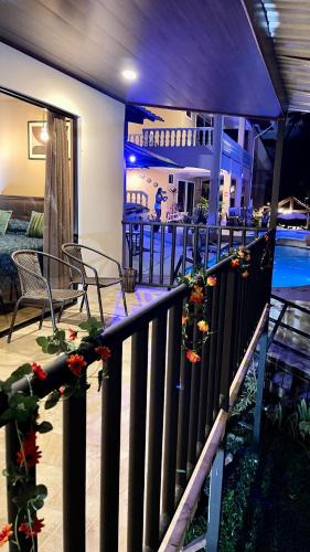 a balcony with a table and chairs and a swimming pool at Hotel Beachfront Vista Hermosa in Jacó