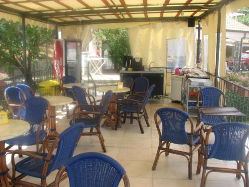 a patio with tables and chairs and a kitchen at Elios Residence Hotel in Sapri