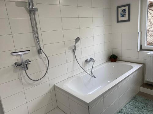 a bathroom with a bath tub with a shower at Rheingold in Kehl am Rhein