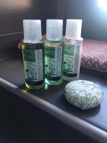 three bottles of essential oils and a rock on a shelf at Soul boutique hotel in Monodendri