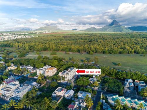 an aerial view of a city with a sign that reads we are near at 373 Wolmar Cosy and Modern Apartment- 200 metres from the Beach and Supermarkets and just next to Domaine de wolmar with views of deers and green natural park in Flic-en-Flac