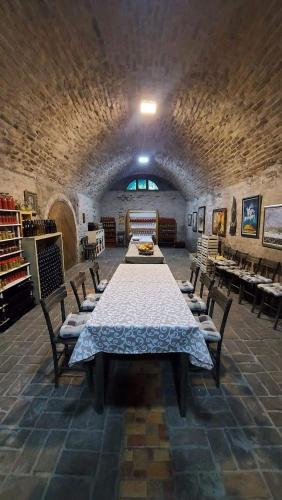 a large room with a long table and chairs at Podrum Miljević in Ledinci