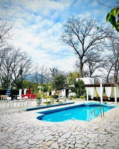 a swimming pool in a yard with a table and chairs at La Casita Inn Bustamante in Bustamante