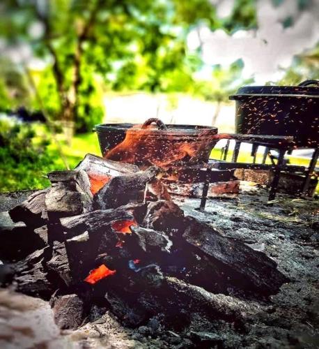 a fire pit with a pot on top of it at La Casita Inn Bustamante in Bustamante