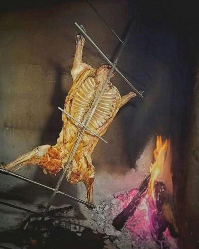 a dead bird is being tied to a fire at La Casita Inn Bustamante in Bustamante