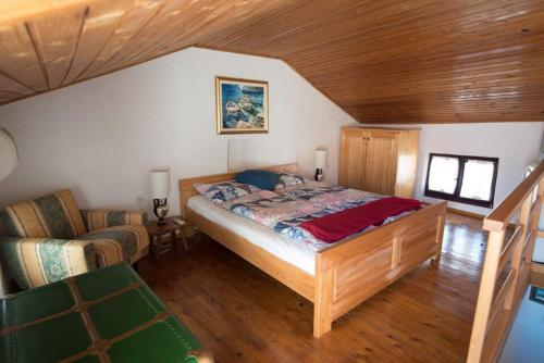 a bedroom with a bed and a chair in a room at Rustica in Vrbnik