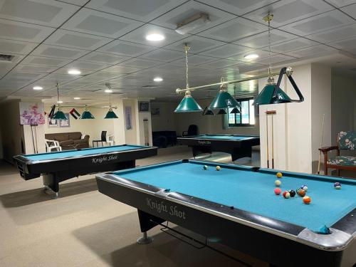 a billiard room with two pool tables in it at Dubai Backpackers in Dubai