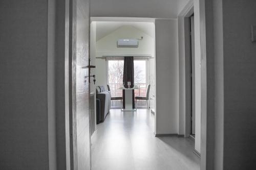 a hallway leading to a dining room with a table at Family Apartmani Le in Leskovac