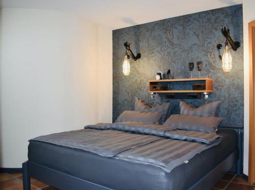 a bedroom with a bed with a blue head board at Sternhaus Nr.1 in Waren