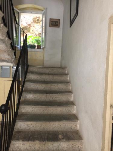 a stairway in a house with a window at Casa Eugénie l'appartement de tante Madeleine vue sur les montagnes in Venaco