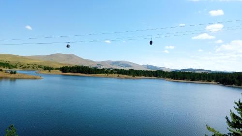 a view of a river with mountains in the background at MK Zlatibor in Zlatibor