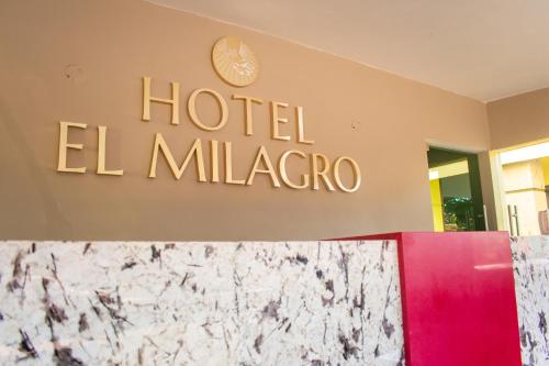 a sign for a hotel el malagro on a wall at Hotel EL MILAGRO in El Fuerte