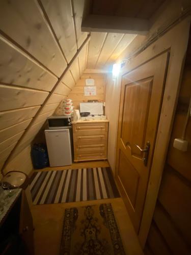 a small room with a staircase leading to a door at Góralskie Pokoje in Witów