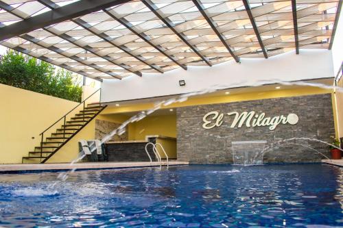 a swimming pool with water shooting out of a building at Hotel EL MILAGRO in El Fuerte