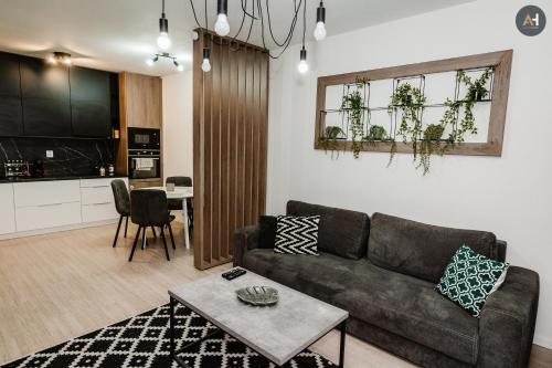 a living room with a couch and a table at AH Mlynská Bašta II Free Parking in Košice