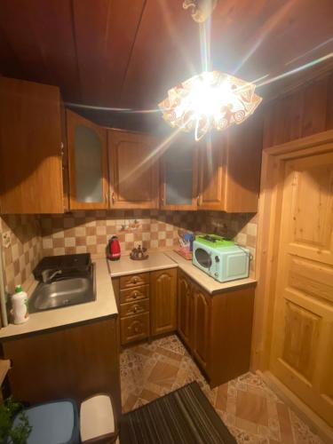 a small kitchen with a sink and a light at Góralskie Pokoje in Witów