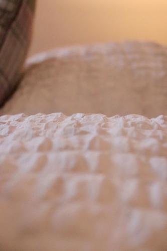 a close up of the top of a white bed at Entire Family Vacation Home . WiFi . FREE Parking in Beeston