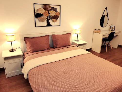 a bedroom with a bed with two lamps and a desk at Rose Garden House in Bucharest