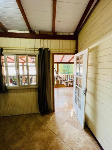 an empty room with a door and a porch at Pousada Rosa Center in Praia do Rosa