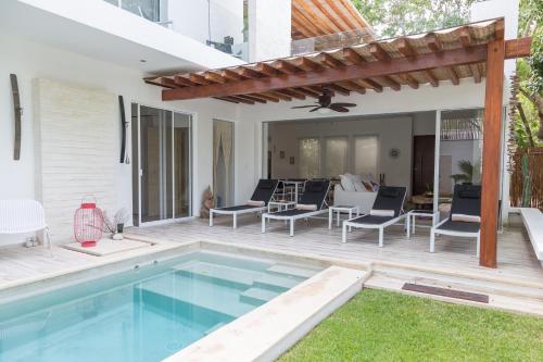 an outdoor patio with a swimming pool and a pergola at Luxury Private Villas , Private Pool, Private garden, Jacuzzi, 24hours security in Tulum