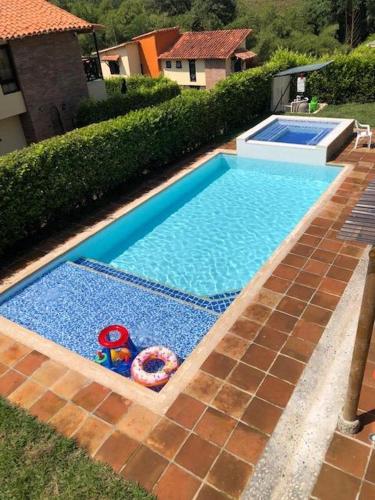 a swimming pool with two toys in the middle of it at Fincas Panaca Jagüey 18 in Quimbaya