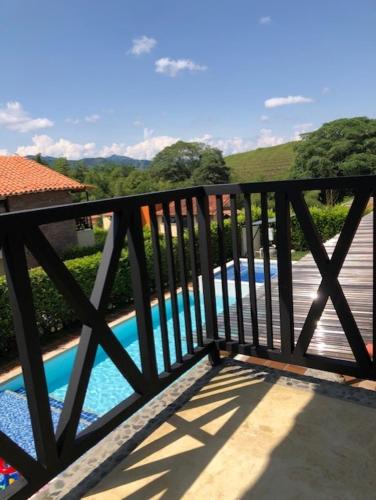 a wooden bridge with a pool of water at Fincas Panaca Jagüey 18 in Quimbaya