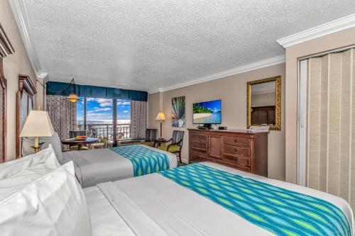 a hotel room with two beds and a television at Holiday Pavilion 405 in Myrtle Beach