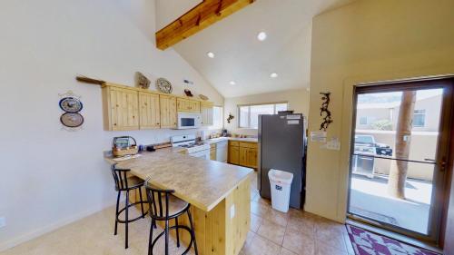 a kitchen with a counter and a refrigerator at Krystal Kiva #K4 in Moab