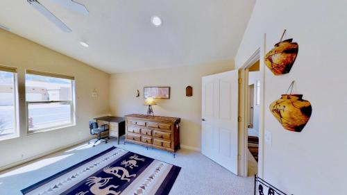 a bedroom with a bed and a desk and a window at Krystal Kiva #K4 in Moab