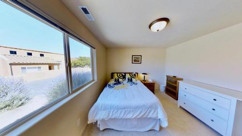 a bedroom with a bed and a large window at Krystal Kiva #K4 in Moab