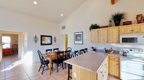 a kitchen and dining room with a table and chairs at Jan's Joy #N3 in Moab