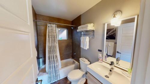 a bathroom with a toilet and a sink and a tub at Moab Flats #4 in Moab