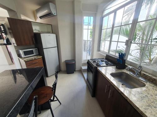 a kitchen with a sink and a refrigerator at Villas Frida Kahlo in Bucerías