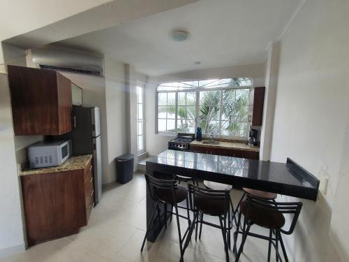 a kitchen with a black counter top in a room at Villas Frida Kahlo in Bucerías