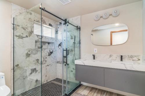 a bathroom with a shower and a sink and a mirror at @Marbella Lane - Charming Tranquil Hideaway in Yucca Valley