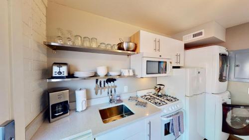 a kitchen with white appliances and a white refrigerator at Moab Flats #7 in Moab