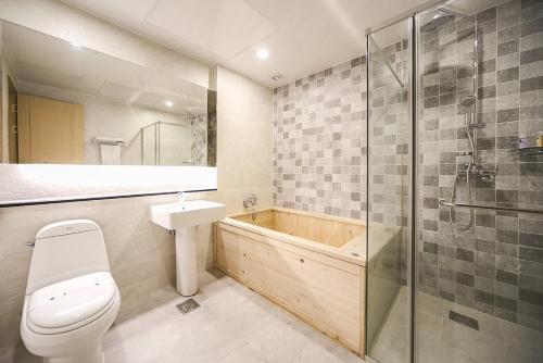 a bathroom with a toilet and a sink and a shower at Paju Golden Hill in Paju