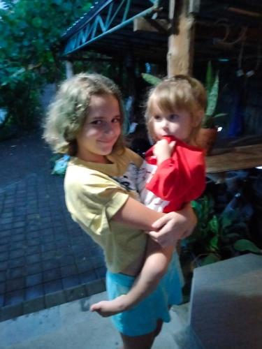 a woman holding a child in her arms at Pier26 Bali Homestay in Nusa Dua