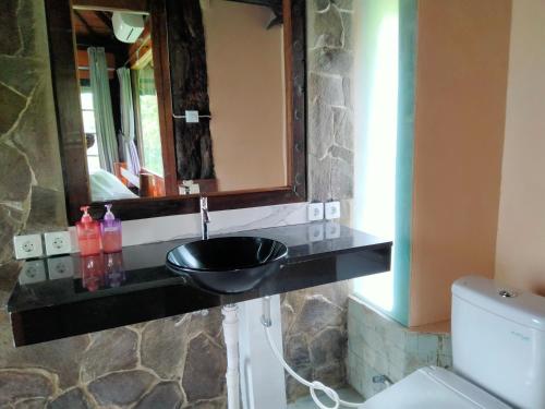 a bathroom with a sink and a mirror at Pier26 Bali Homestay in Nusa Dua