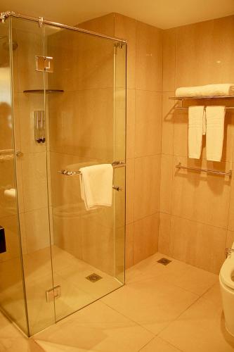 a shower with a glass door in a bathroom at Lion Hotel & Plaza Manado in Manado