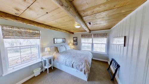 a bedroom with a bed and two windows at Pack Creek ~ Road House in Moab