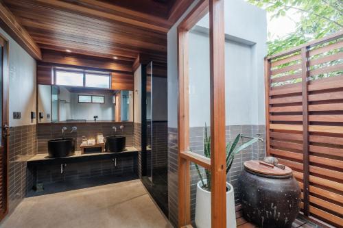 a bathroom with a sink and a mirror at Banana Fan Sea Resort in Chaweng