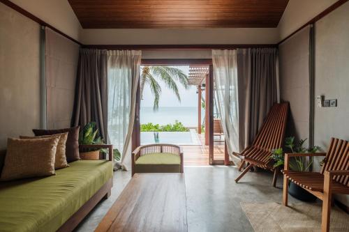 a living room with a couch and two chairs at Banana Fan Sea Resort in Chaweng