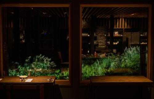 a window of a restaurant with a table and a view at kamosu mori in Tokamachi