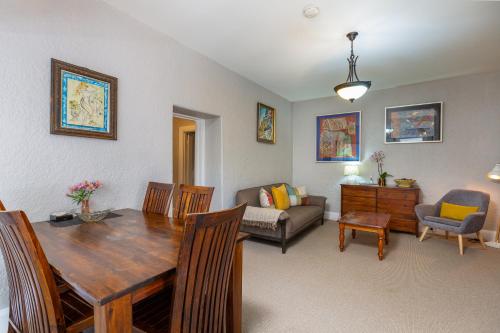 a living room with a dining table and a couch at Maison del Mar in Hobart