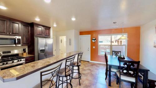 a kitchen with a counter and a table with chairs at Slick Rock Reserve #12A3 in Moab